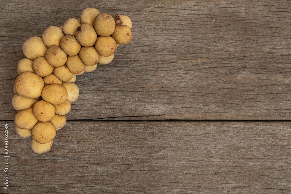 Longkong or langsat popular Tropical fruit from Southeast Asia. sweet and juicy. on wooden background. Longkong or langsat popular Tropical fruit from Southeast Asia. sweet and juicy. on wooden background.