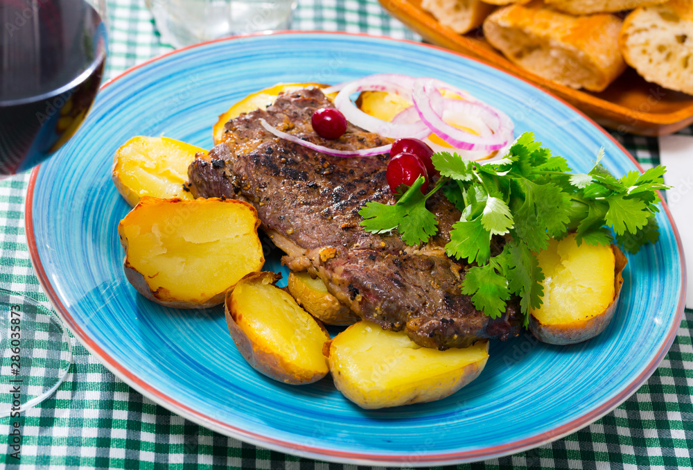 Beef steak with slices of baked potato