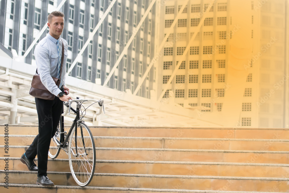 Businessman going to work by bicycle.Handsome man enjoying city ride by bicycle. Businessman going to work by bicycle.Handsome man enjoying city ride by bicycle.
