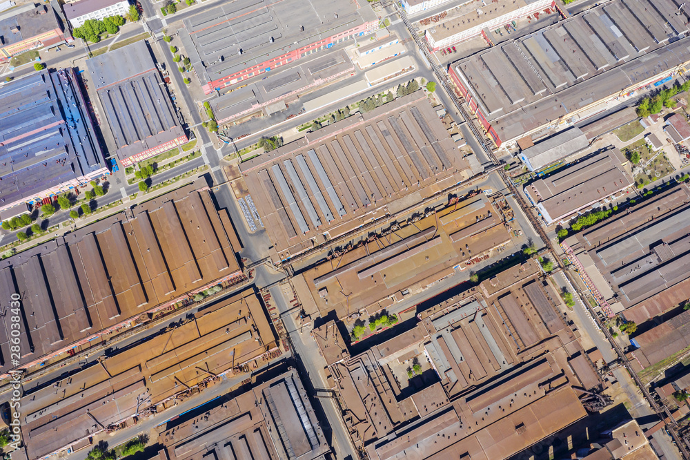 aerial drone image of city industrial zone. rusty metal roofs of industrial buildings aerial drone image of city industrial zone. rusty metal roofs of industrial buildings