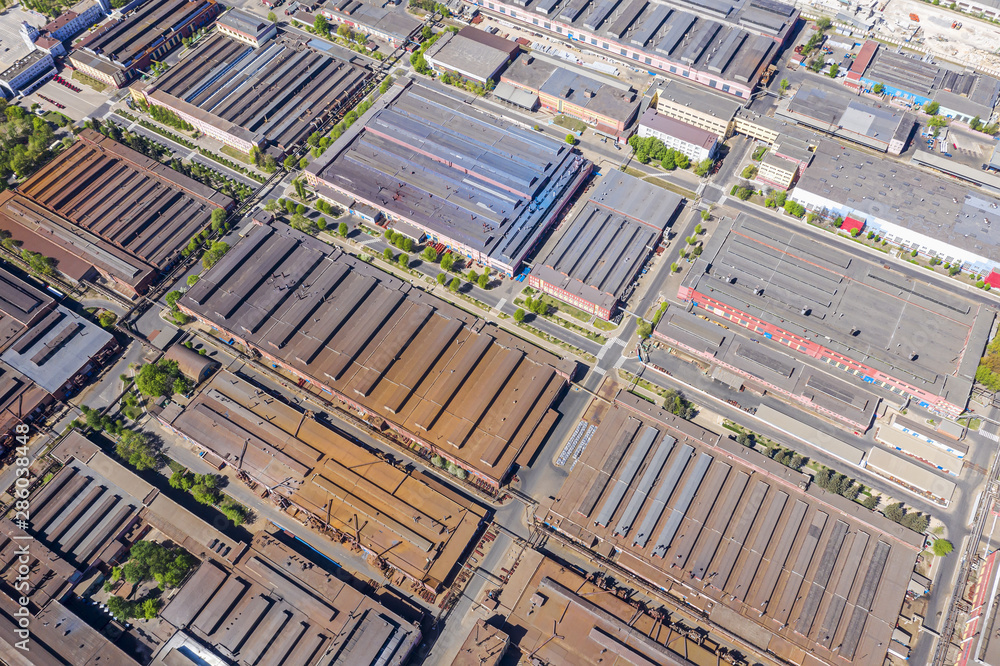 city industrial zone. metal roofs of industrial plants and warehouses. aerial top view