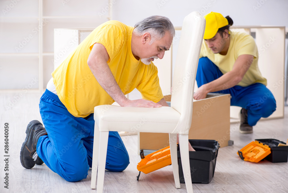 Two contractors carpenters working indoors Two contractors carpenters working indoors