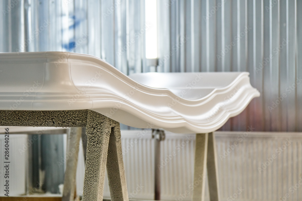 Classic wardrobe crown molding. Production of wood furniture. Furniture manufacture. Close-up Classic wardrobe crown molding. Production of wood furniture. Furniture manufacture. Close-up