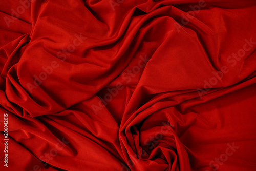 Background image of crumpled fabric. Red cloth