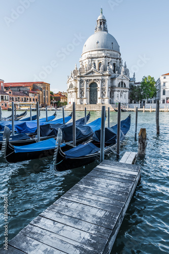 enetian gondolas at the wooden pier © andrey_iv