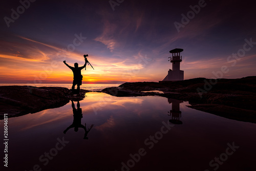 Silhouette Photographer With Lighthouse at sunset