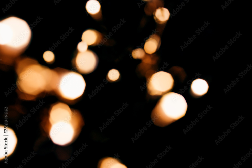 Golden abstract bokeh sparkle on black isolated background. Holiday concept. Place for design. Festive concept.