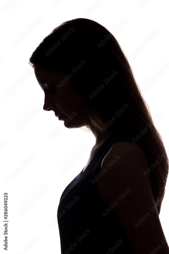 Young woman look down with flowing hair - vertical silhouette Young woman look down with flowing hair - vertical silhouette