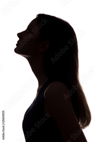 Young woman looking up - vertical silhouette