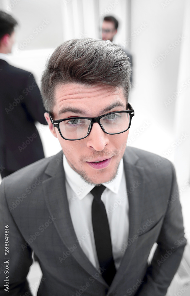 close up.confident young businessman on blurred office background close up.confident young businessman on blurred office background