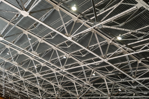 Metal trusses covering an industrial long-span building with indoors floodlights