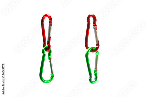Two connected climbing green and red carabiners isolated on white