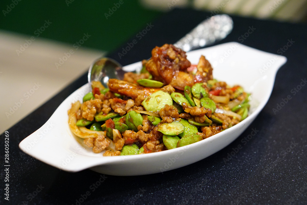 Stir-Fried Twisted cluster bean (Bitter bean or Stink bean) with shrimps paste, Traditional Thai food recipe, Popular in Thailand.