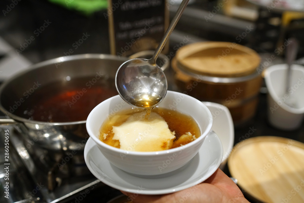 Homemade tofu pudding with ginger syrup, Chinese traditional dessert, Popular in Thailand. Homemade tofu pudding with ginger syrup, Chinese traditional dessert, Popular in Thailand.