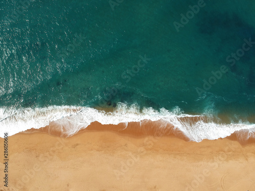Aerial view of waves crashing onto the beach
