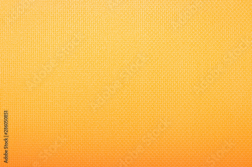 The texture of Karimat  an orange yoga mat. Can be used as wallpaper  background  texture.