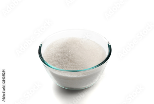 Sugar in glass bowl isolated on white background