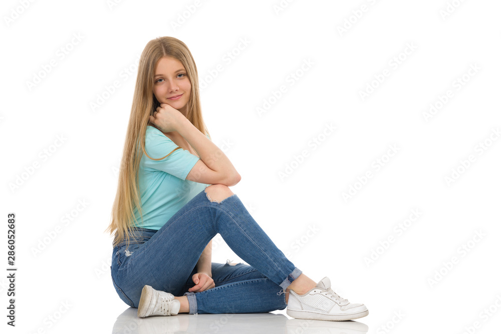 Beautiful Teenage Girl Is Sitting Relaxed On A Floor Beautiful Teenage Girl Is Sitting Relaxed On A Floor
