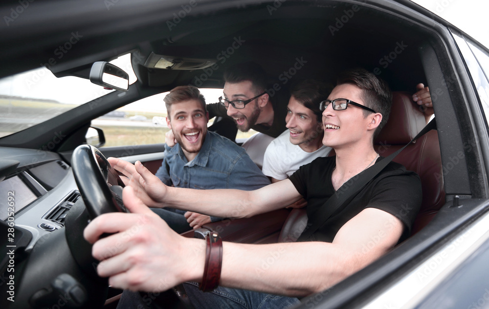 side view . friends sitting in the car and looking at the camera. side view . friends sitting in the car and looking at the camera.