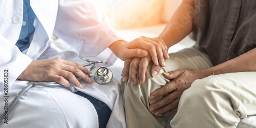 Parkinson's disease patient, Arthritis hand and knee pain or mental health care with geriatric doctor consulting examining comforting elderly senior aged adult in medical exam clinic or hospital