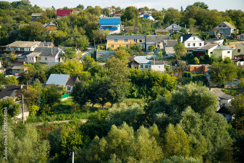 rustic houses of Ukrainian Eastern European village landmark and green trees garden landscape photography from above 