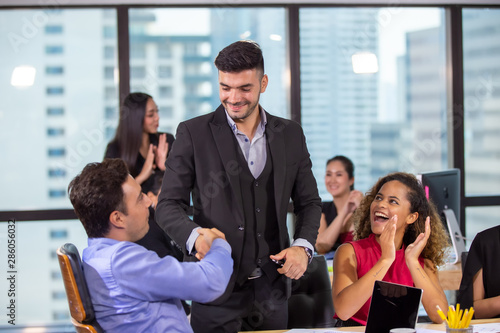 group of joyful business colleagues celebrating their successful