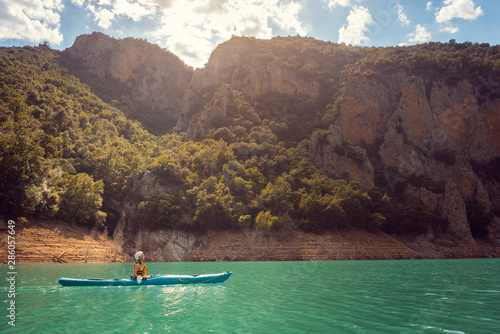 Woman on a kayak in the Pyrenees mountains in Catalonia