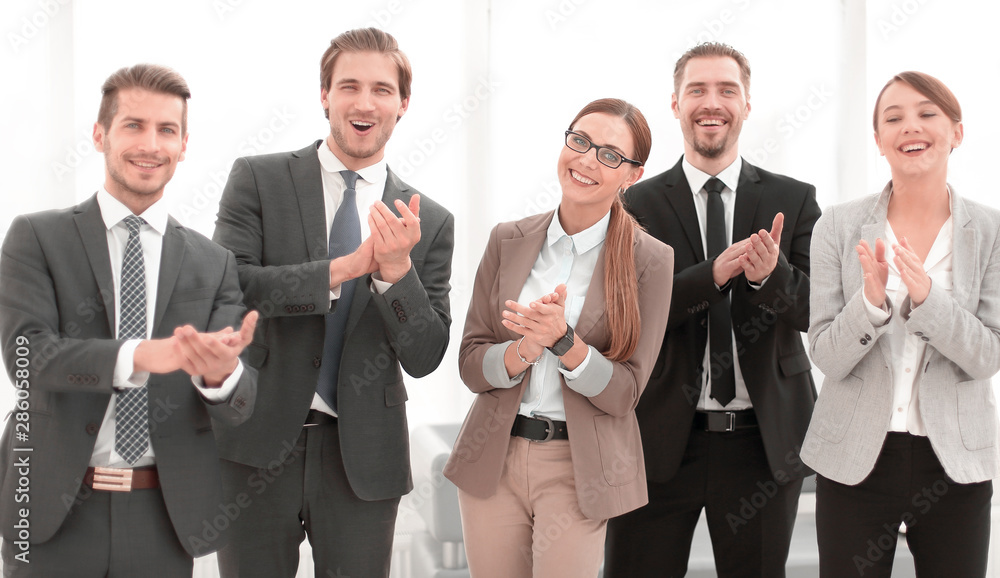 smiling business team applauds their success smiling business team applauds their success