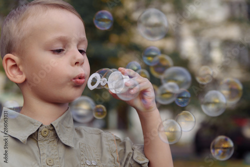 Little boy blowing bubbles. The concept of lifestyle and childhood.