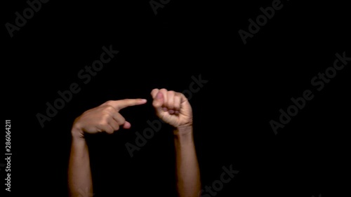 Two Hands Make the Sex Gesture on a Black Background
