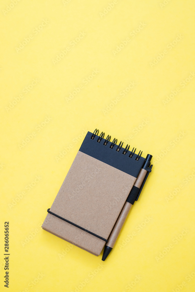spiral notepad with blank sheet, flat lay on yellow background spiral notepad with blank sheet, flat lay on yellow background