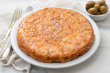 typical spanish food Tortilla with smoked meat and potato on white dish