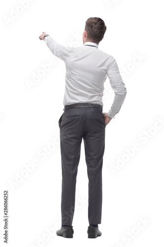 rear view.smiling young businessman pointing at white screen