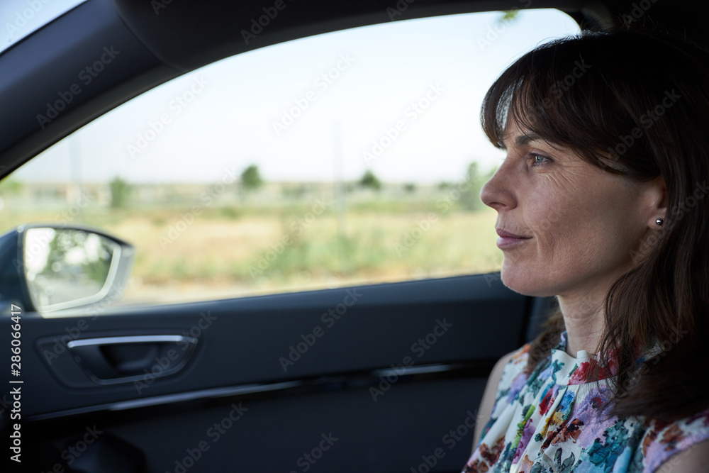 woman sitting in the passenger seat of a car