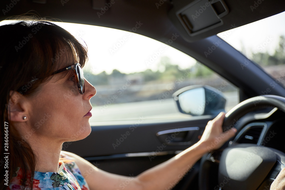 view of a woman driving her car