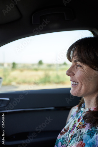 woman sitting in the passenger seat of a car © luismicss