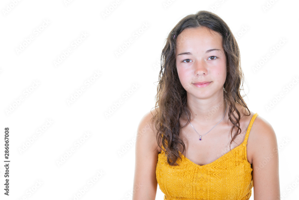 Portrait of young happy brunette curly caucasian teenage girl smiling in white copy space background Portrait of young happy brunette curly caucasian teenage girl smiling in white copy space background