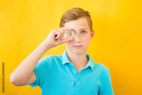 Fotografie Handsome boy looks through a glass prism