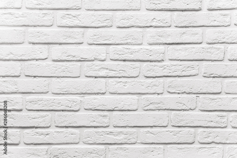 Obraz premium long white brick wall. The texture of the old brick painted with white paint