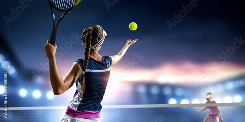 Young woman playing tennis in action © Sergey Nivens
