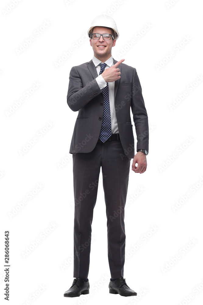 smiling businessman in a protective helmet pointing somewhere to the side smiling businessman in a protective helmet pointing somewhere to the side