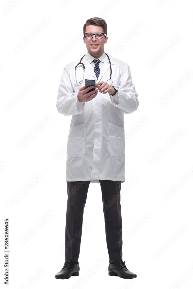smiling doctor therapist reading messages on his smartphone. isolated on white smiling doctor therapist reading messages on his smartphone. isolated on white
