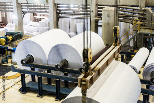 The production of paper rolls in a printing plant, recycling of waste paper. photo