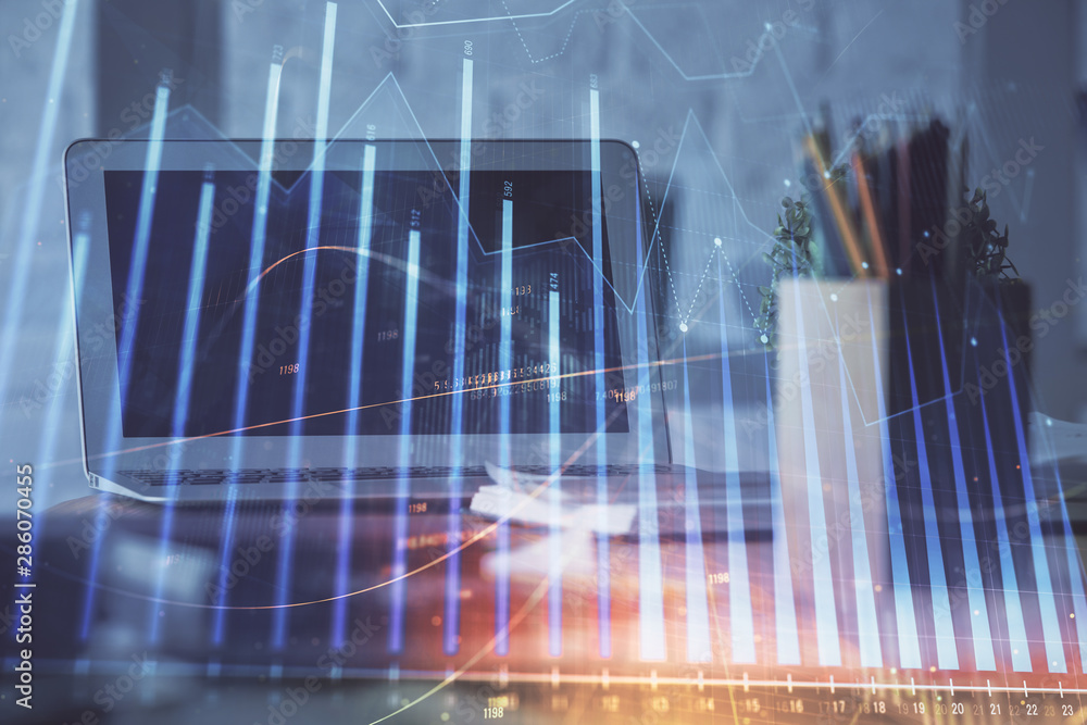 Stock market graph on background with desk and personal computer. Double exposure. Concept of financial analysis. Stock market graph on background with desk and personal computer. Double exposure. Concept of financial analysis.