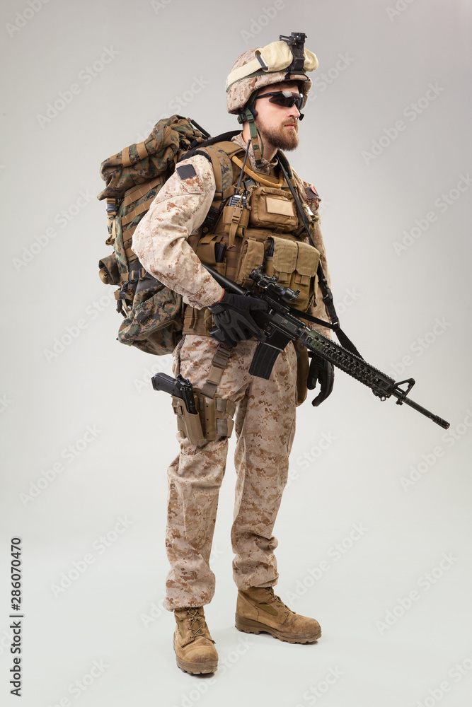 Portrait of a young American US Marine Corps soldier over grey background Portrait of a young American US Marine Corps soldier over grey background