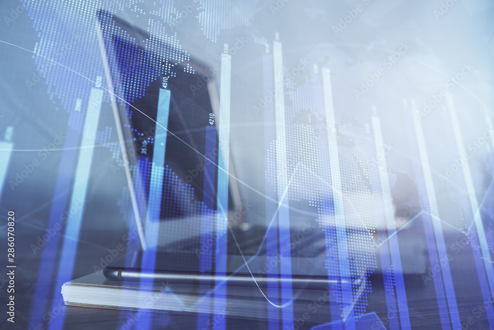 Stock market graph and table with computer background. Double exposure. Concept of financial analysis. Stock market graph and table with computer background. Double exposure. Concept of financial analysis.