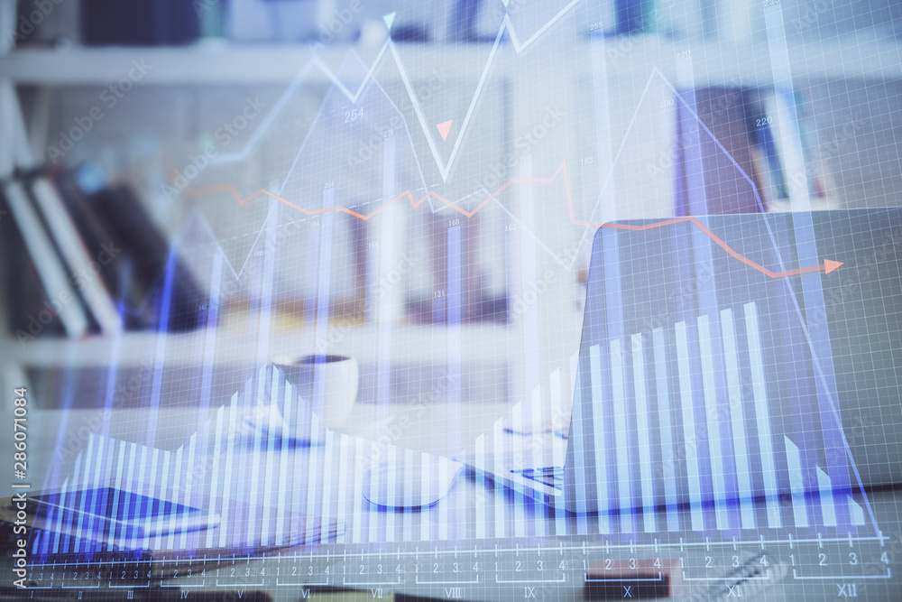 Financial market graph hologram and personal computer on background. Multi exposure. Concept of forex. Financial market graph hologram and personal computer on background. Multi exposure. Concept of forex.