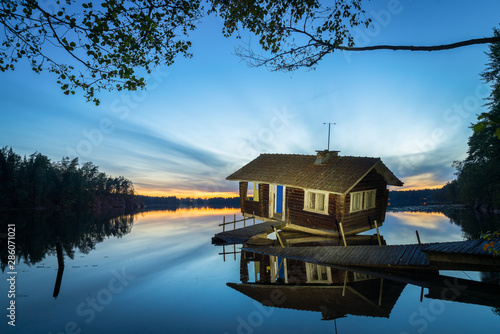 abandoned house on the lake and sunset in Finland