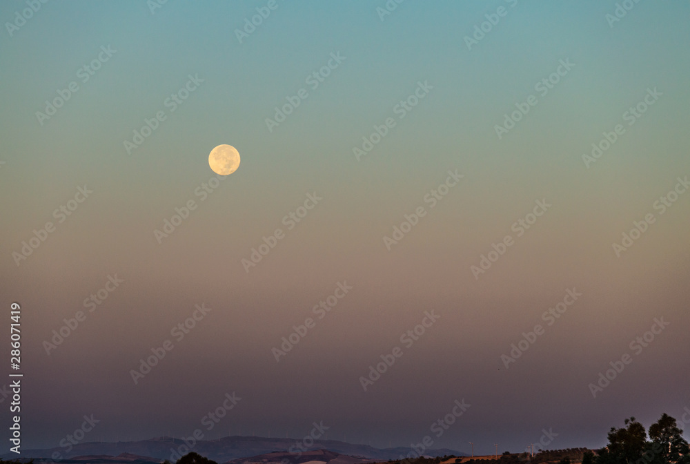 The Full Moon at Sunrise, Sicily, Italy, Europe The Full Moon at Sunrise, Sicily, Italy, Europe