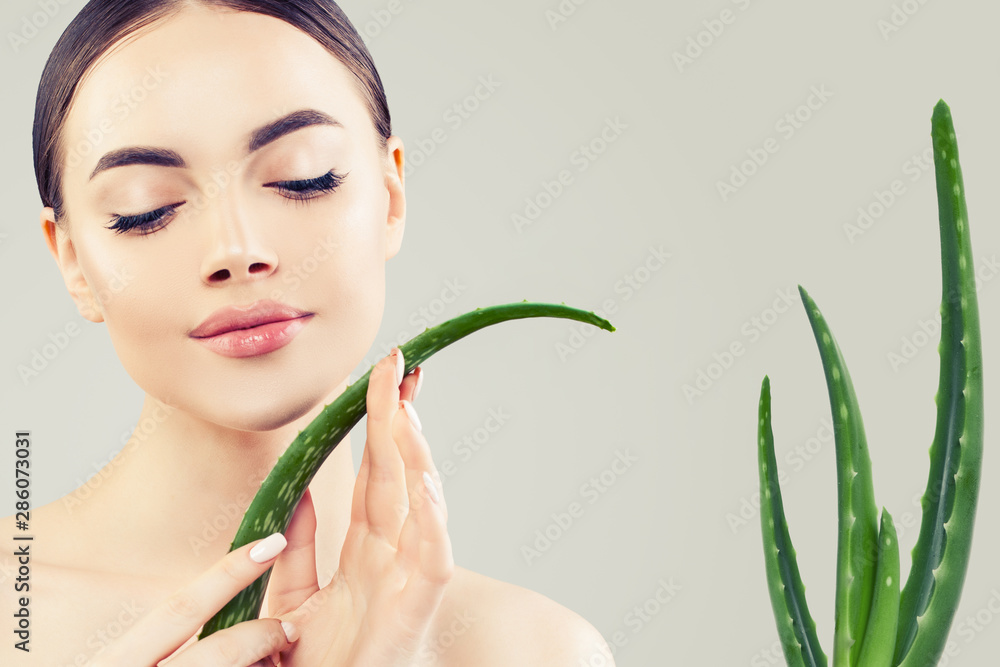 Beauty portrait of perfect woman with aloe leaves in her hands Beauty portrait of perfect woman with aloe leaves in her hands